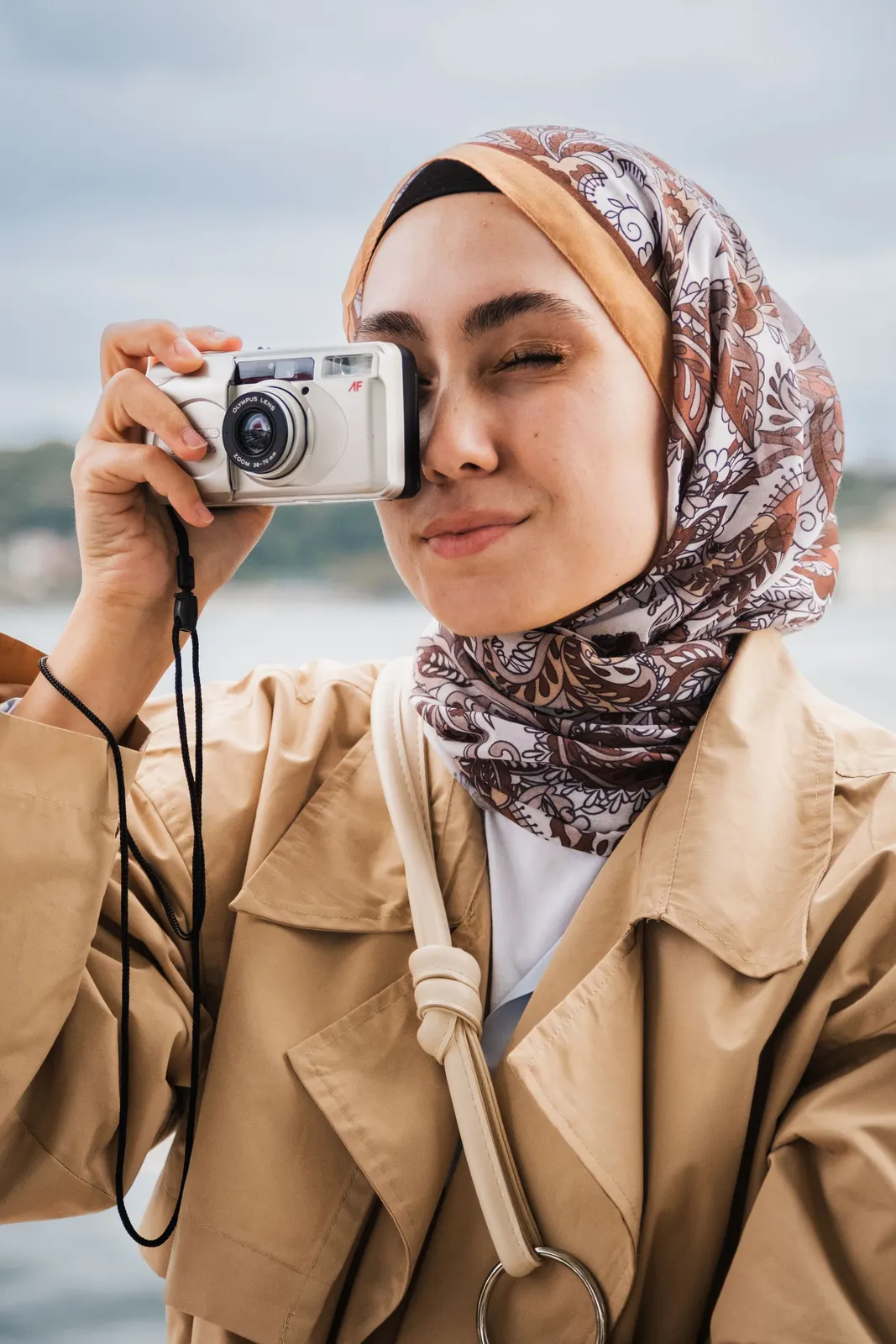 Mocha paisley bandana tied over an inner cap