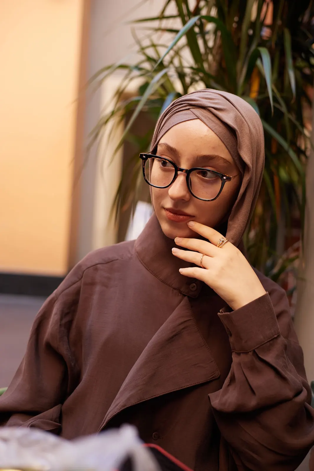 Cocoa hijab and glasses in a café