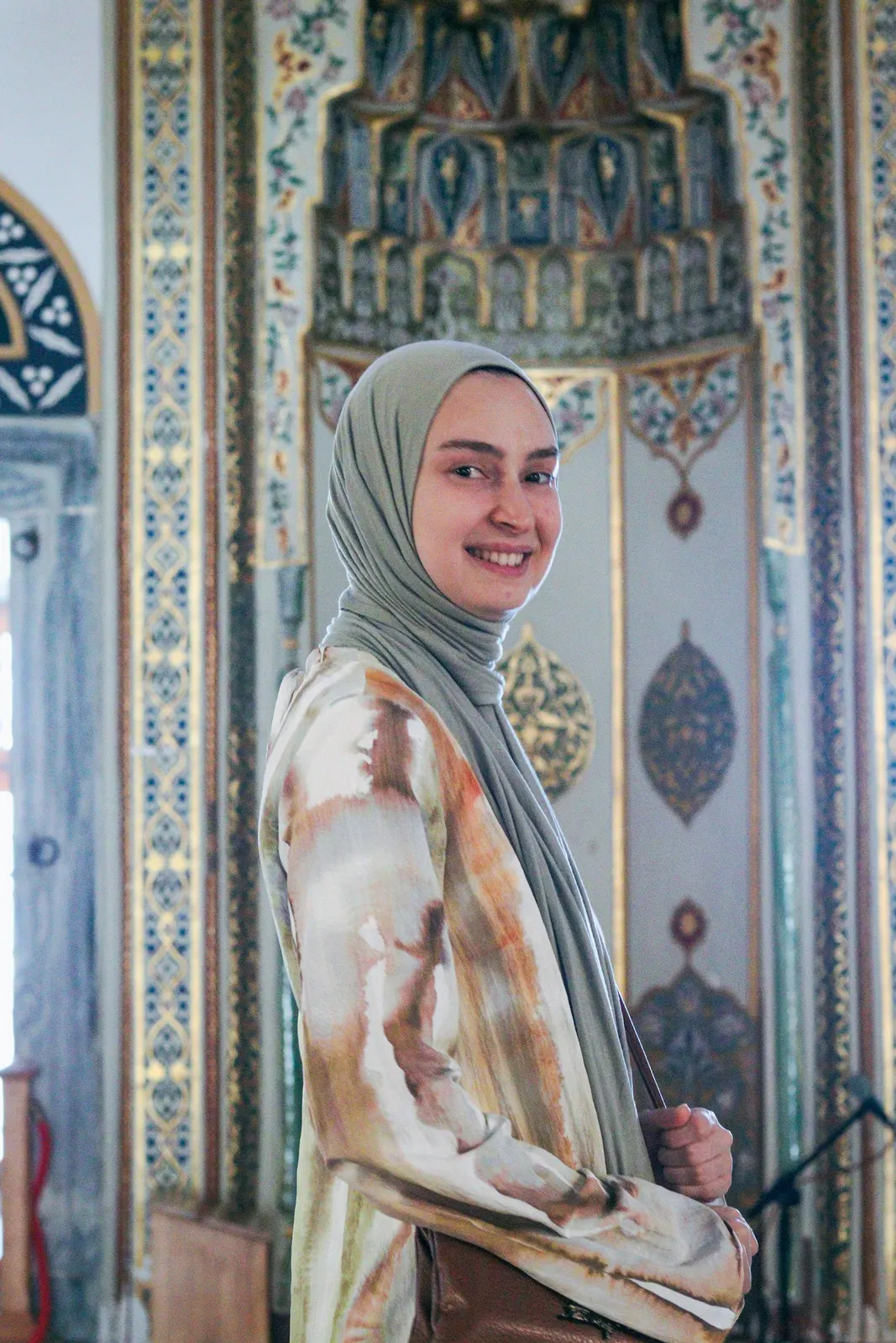Olive hijab against painted tiles